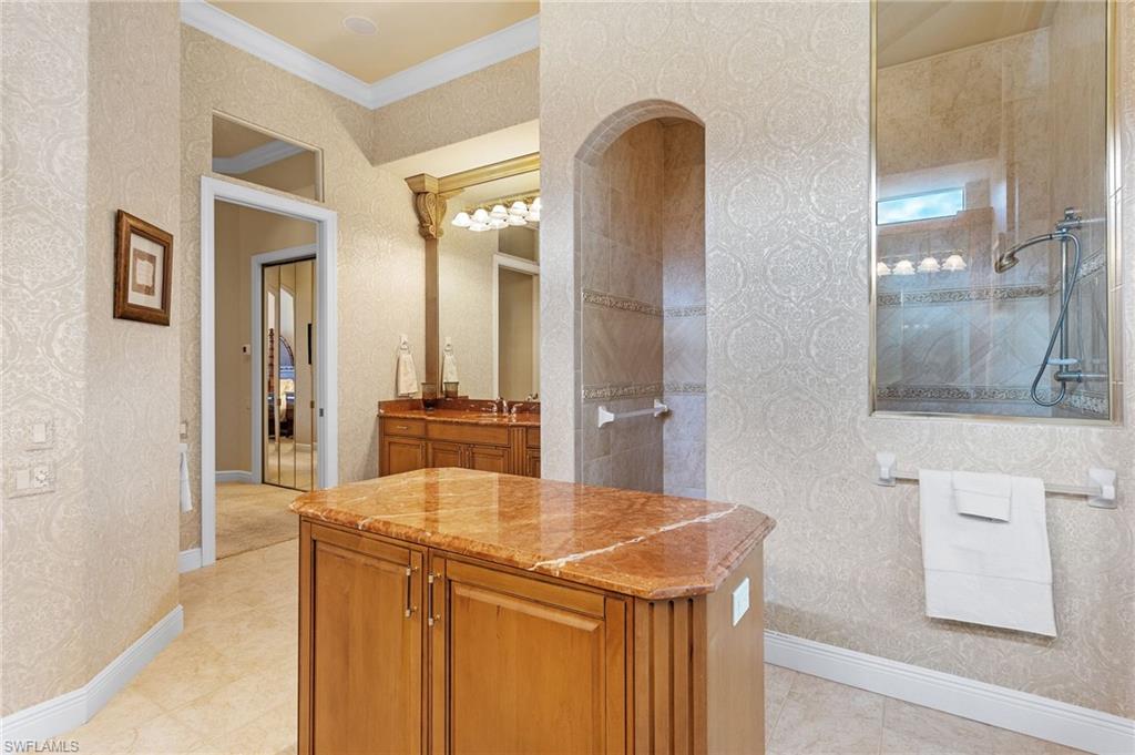 7511 Hogan Court Naples, FL 34113 - Photo 27 of 50 a kitchen with stainless steel appliances kitchen island a chandelier