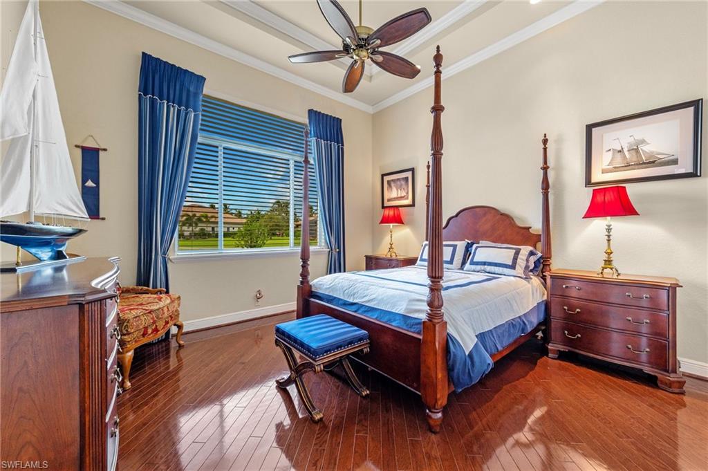 7511 Hogan Court Naples, FL 34113 - Photo 28 of 50 a bedroom with a bed and a table