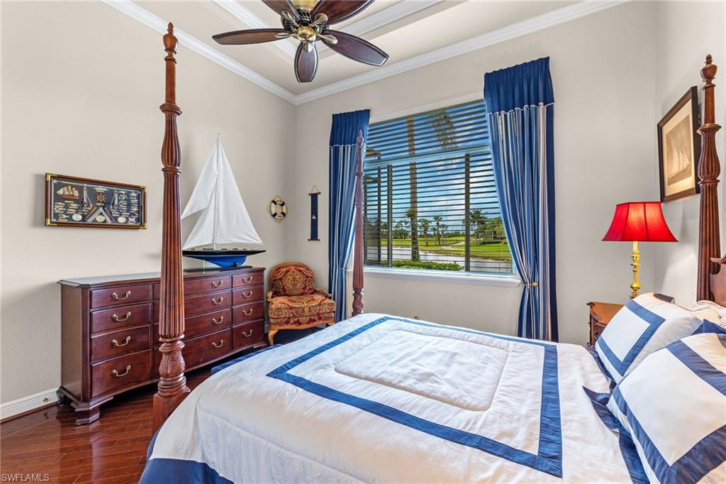 7511 Hogan Court Naples, FL 34113 - Photo 29 of 50 a bedroom with a bed and wooden floor