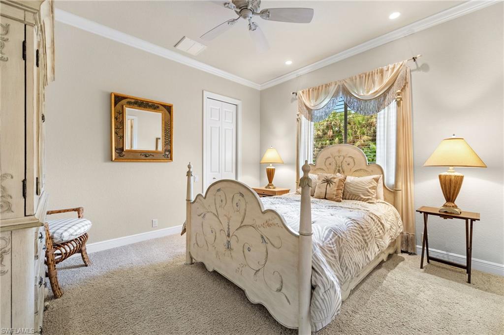 7511 Hogan Court Naples, FL 34113 - Photo 31 of 50 a bed room with a bed and a chandelier