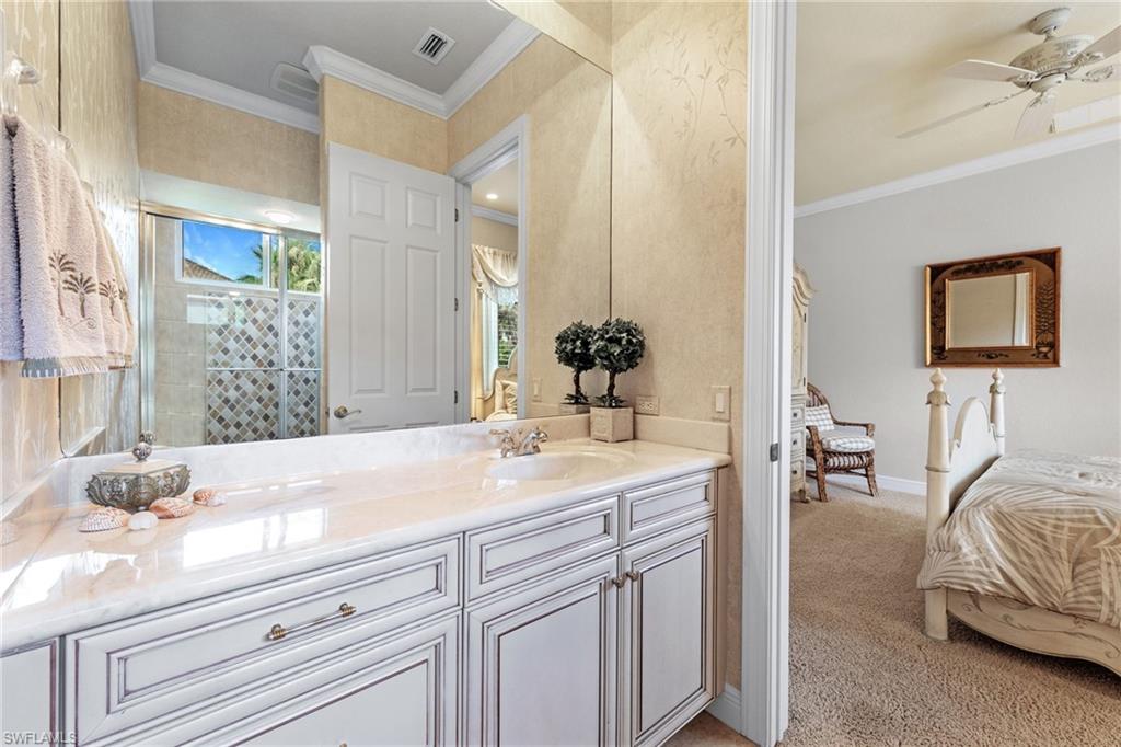 7511 Hogan Court Naples, FL 34113 - Photo 32 of 50 a en suite bathroom with sink and mirror