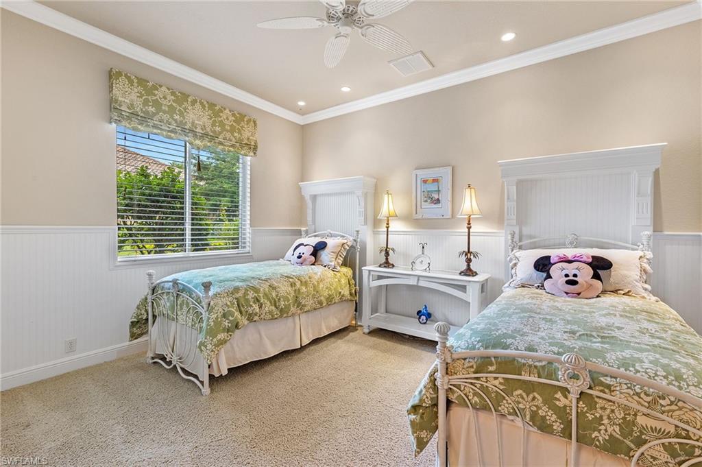 7511 Hogan Court Naples, FL 34113 - Photo 33 of 50 a bedroom with a bed and a chandelier