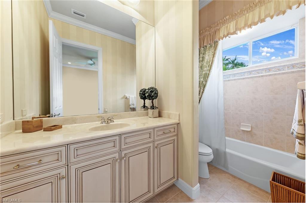 7511 Hogan Court Naples, FL 34113 - Photo 34 of 50 a bathroom with a granite countertop sink toilet and shower