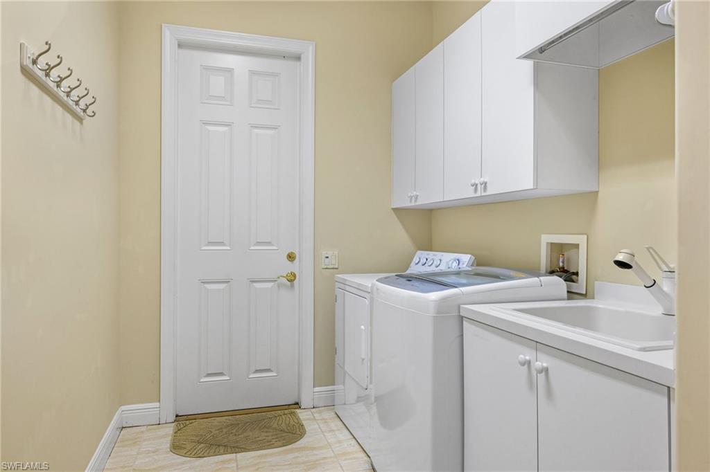 7511 Hogan Court Naples, FL 34113 - Photo 35 of 50 a utility room with dryer and washer
