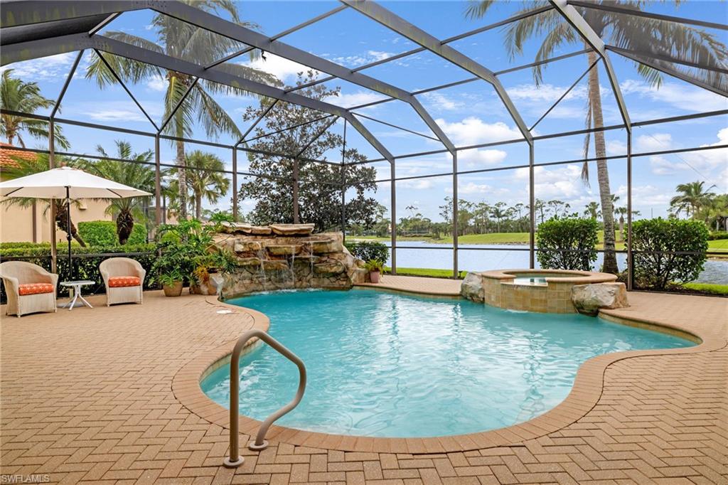7511 Hogan Court Naples, FL 34113 - Photo 36 of 50 a view of a swimming pool with a patio