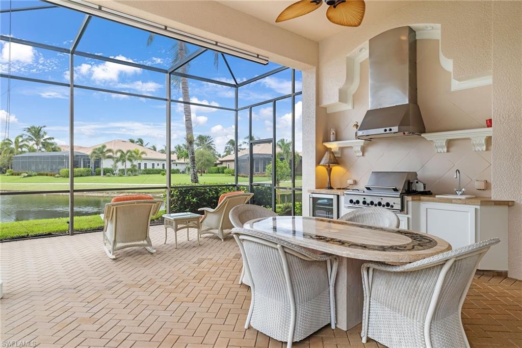 7511 Hogan Court Naples, FL 34113 - Photo 39 of 50 a kitchen with a table chairs stove and cabinets