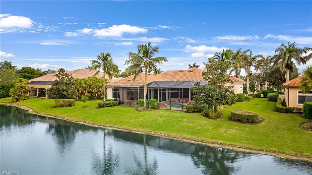 7511 Hogan Court Naples, FL 34113 - Photo 42 of 50 a view of a house with swimming pool and a yard