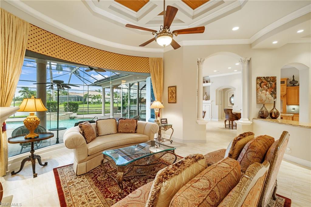 7511 Hogan Court Naples, FL 34113 - Photo 6 of 50 a living room with furniture a ceiling fan and a large window
