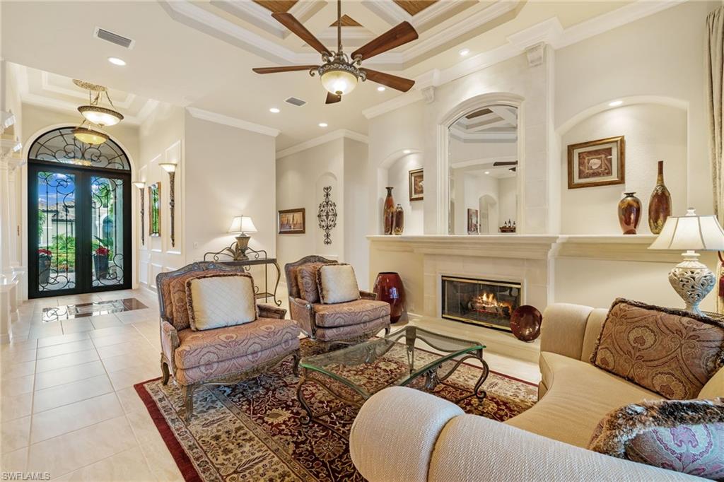 7511 Hogan Court Naples, FL 34113 - Photo 7 of 50 a living room with furniture fireplace and window