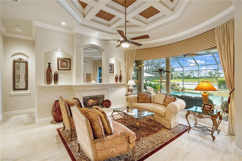 7511 Hogan Court Naples, FL 34113 - Photo 8 of 50 a living room with furniture and a floor to ceiling window