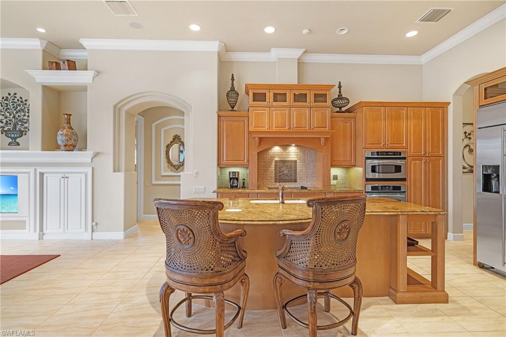 7511 Hogan Court Naples, FL 34113 - Photo 10 of 50 a large kitchen with a table and chairs