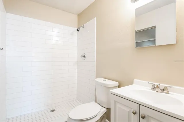 a white toilet sitting next to a bathroom sink