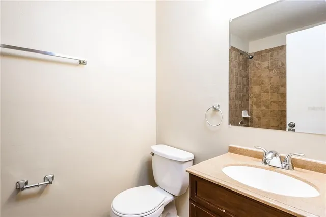 a bathroom with a sink mirror and toilet