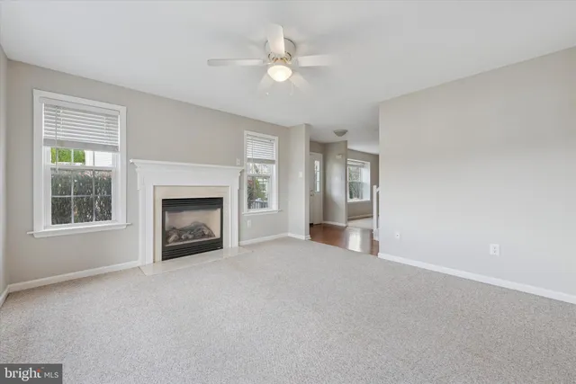 a view of a livingroom with a fireplace and a window