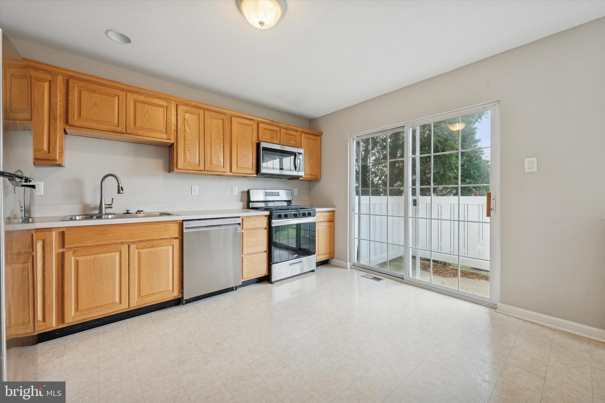63 Granite Lane, Unit 2 Chester Springs, PA 19425 - Photo 5 of 15 a kitchen with white cabinets and white appliances