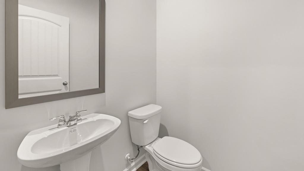 23 Rustin Ridge Dahlonega, GA 30533 - Photo 12 of 27 a white toilet sitting next to a bathroom sink