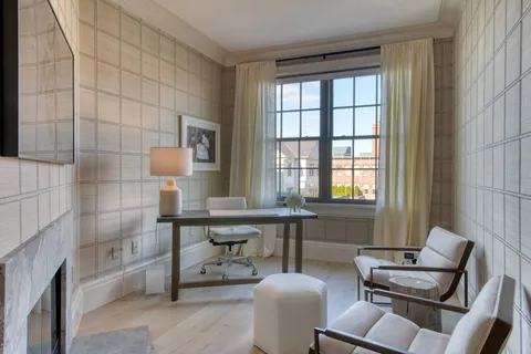 a bedroom with a bed and large window