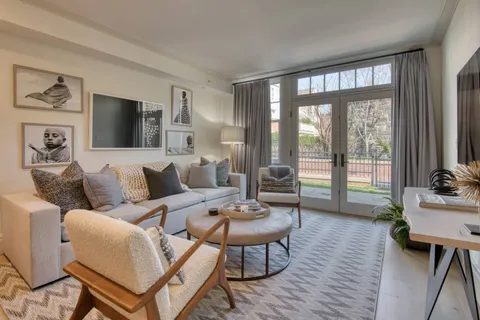 a living room with furniture and a wooden floor