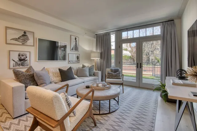 a living room with furniture and a wooden floor
