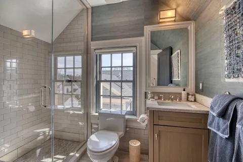 a view of a patio with a table and chairs under an umbrella
