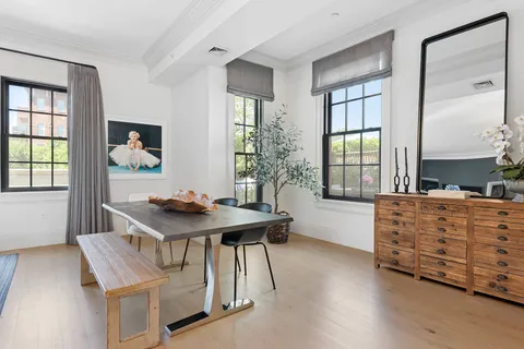 an aerial view of multi story residential apartment building with a yard