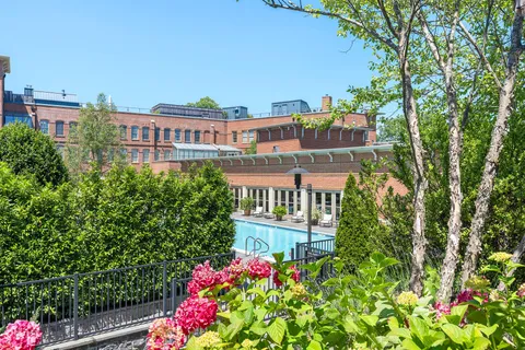 a view of a balcony with chairs and wooden floor