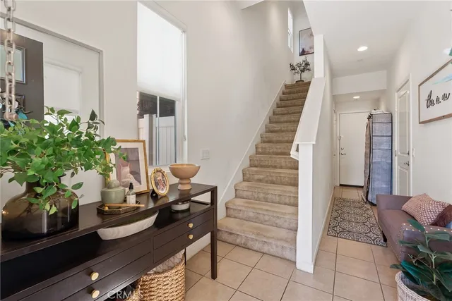 a living room with furniture a chandelier and a dining table