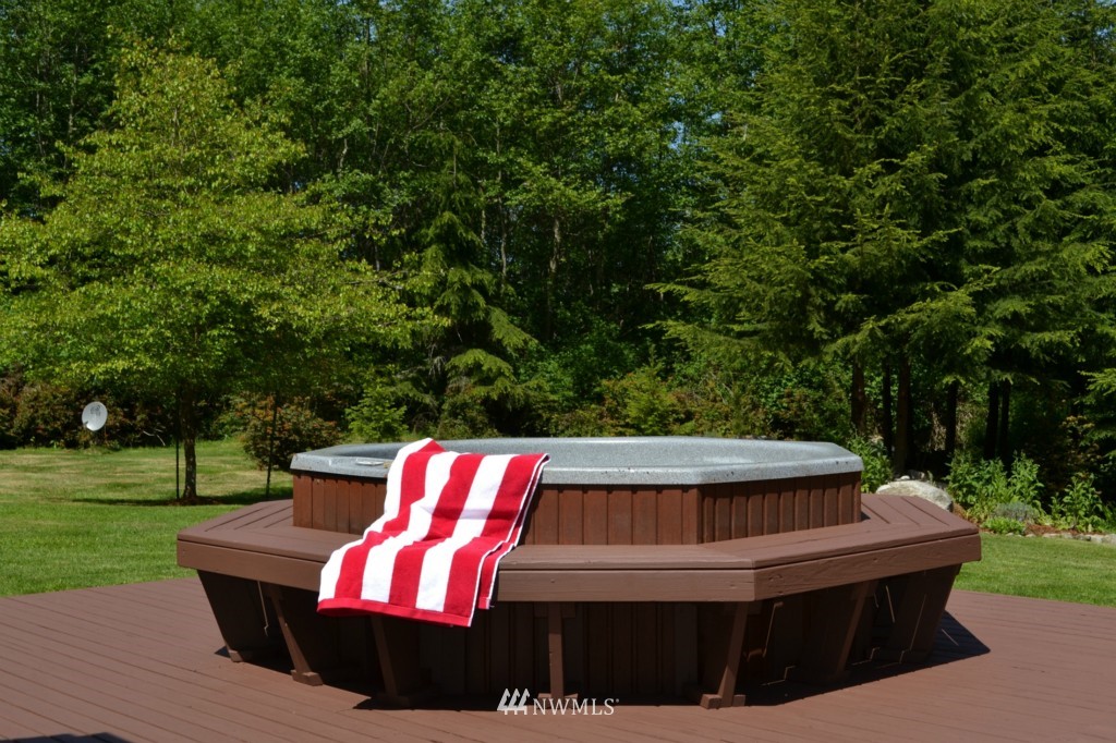 2469 Goss Ridge Road Freeland, WA 98249 - Photo 18 of 25 a view of a wooden deck with chairs and a yard