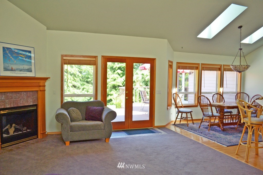 2469 Goss Ridge Road Freeland, WA 98249 - Photo 7 of 25 a living room with furniture and a fireplace