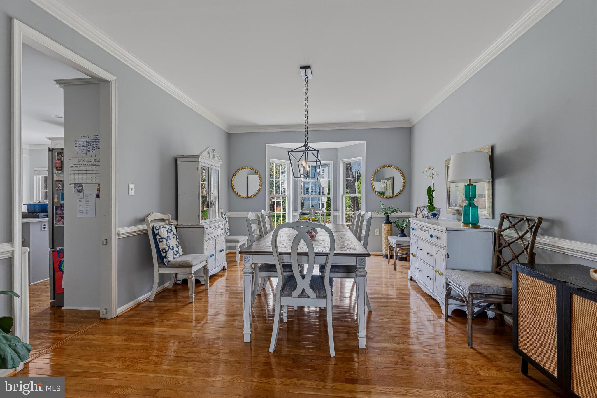 1403 Harle Place Southwest Leesburg, VA 20175 - Photo 12 of 41 a dining room with furniture a chandelier and wooden floor