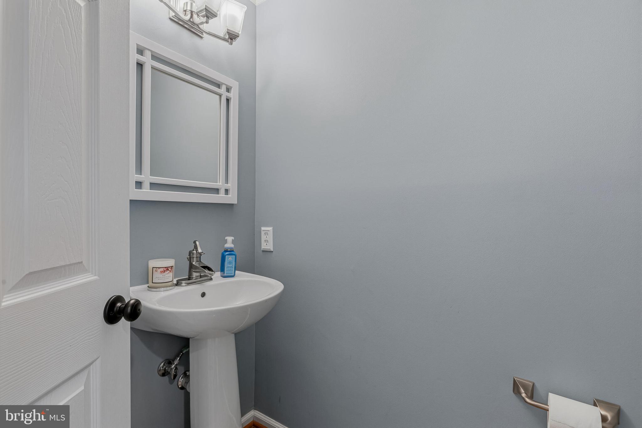 1403 Harle Place Southwest Leesburg, VA 20175 - Photo 17 of 41 a bathroom with a sink a mirror and toilet