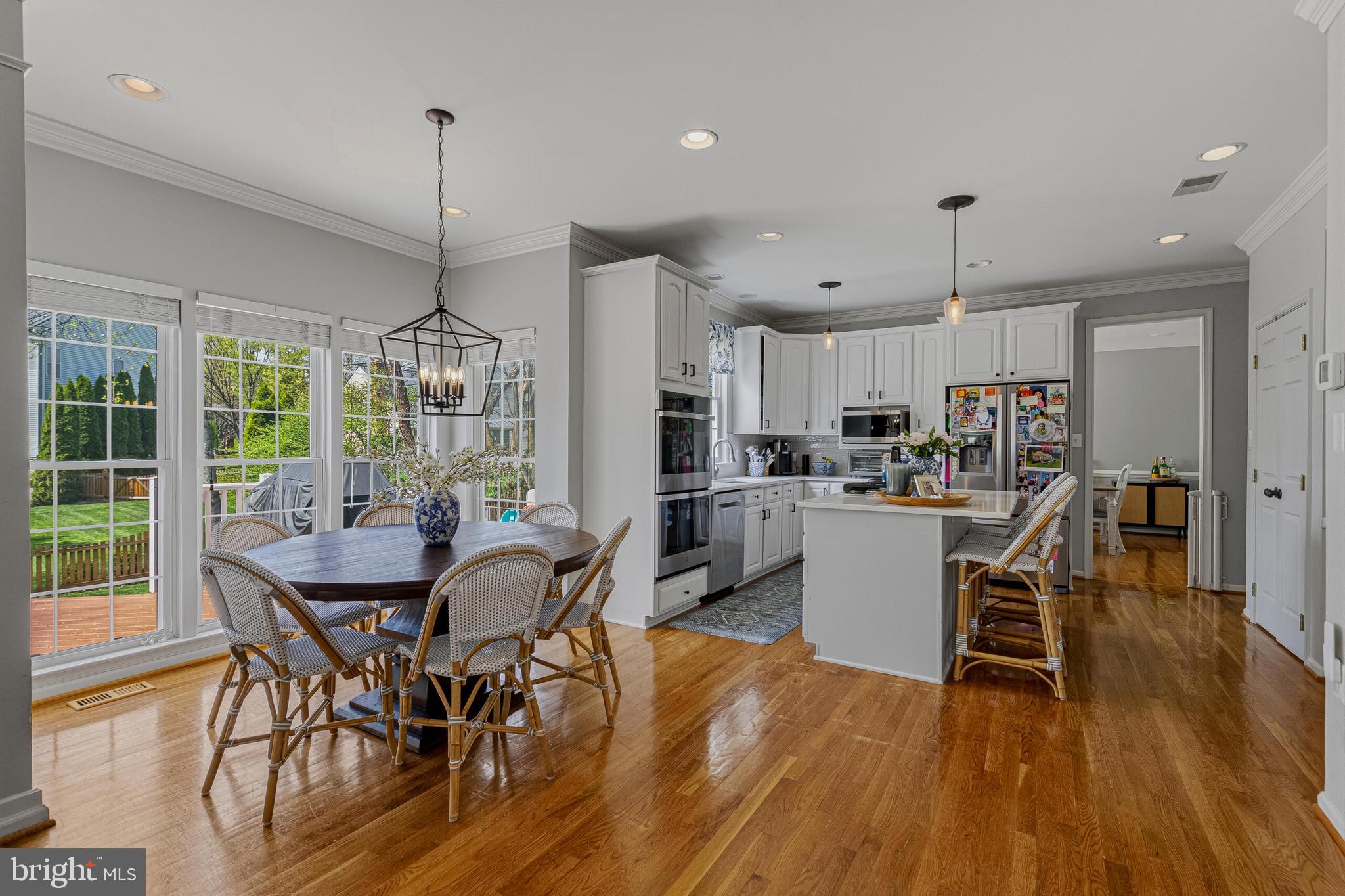 1403 Harle Place Southwest Leesburg, VA 20175 - Photo 6 of 41 a view of a dining room and livingroom with furniture wooden floor a chandelier