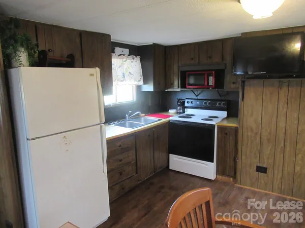 a white refrigerator freezer sitting inside of a kitchen