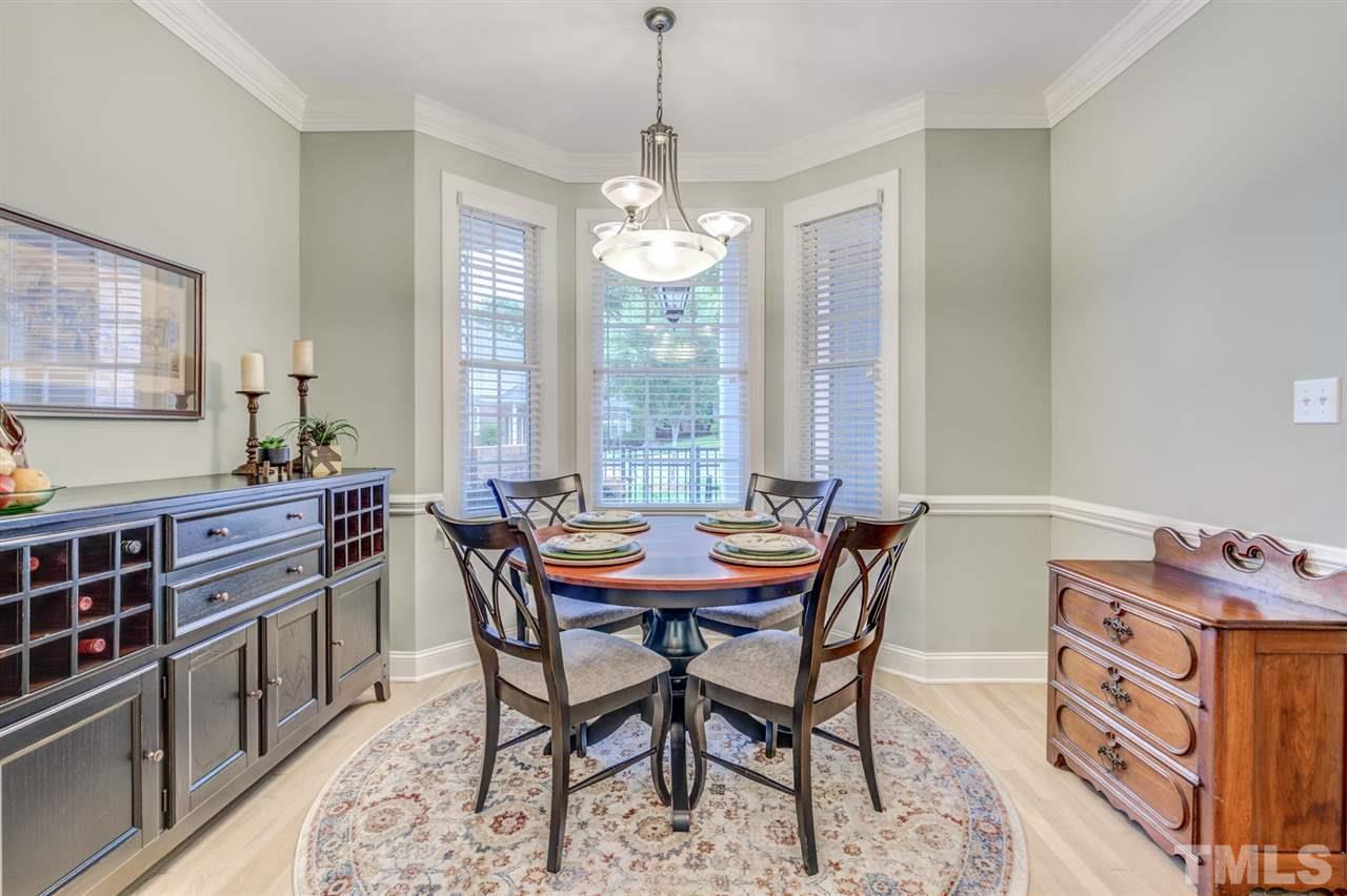 3606 Burwell Rollins Circle Raleigh, NC 27612 - Photo 11 of 30 a dining room with furniture a chandelier and window