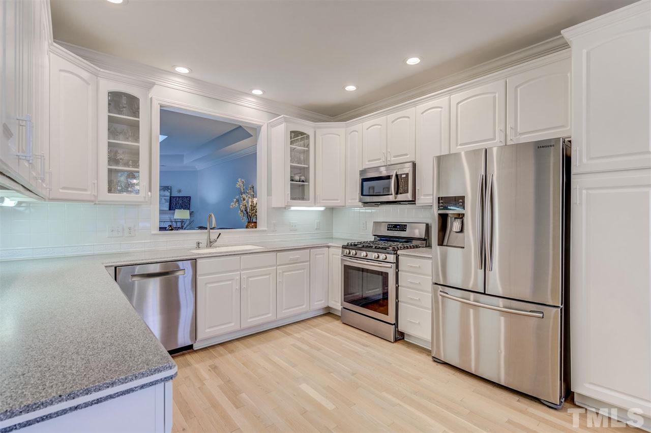 3606 Burwell Rollins Circle Raleigh, NC 27612 - Photo 12 of 30 a kitchen with stainless steel appliances granite countertop a refrigerator stove microwave and sink