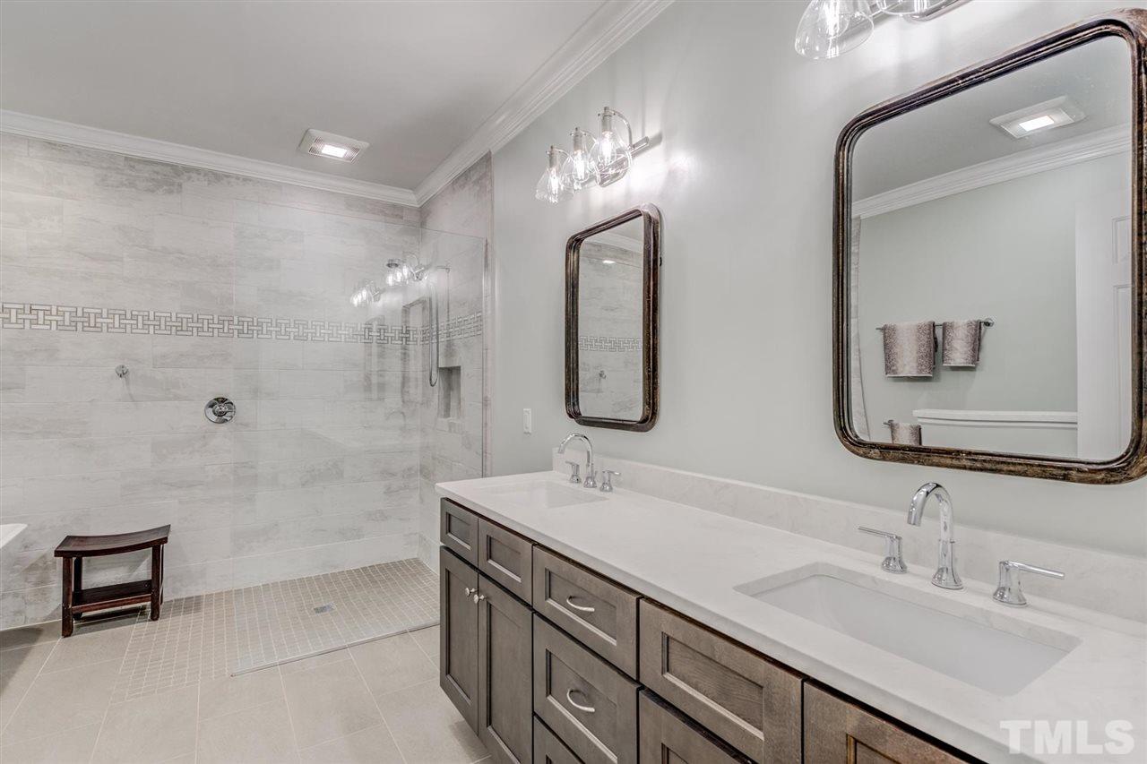 3606 Burwell Rollins Circle Raleigh, NC 27612 - Photo 18 of 30 a bathroom with a double vanity sink mirror and bathtub