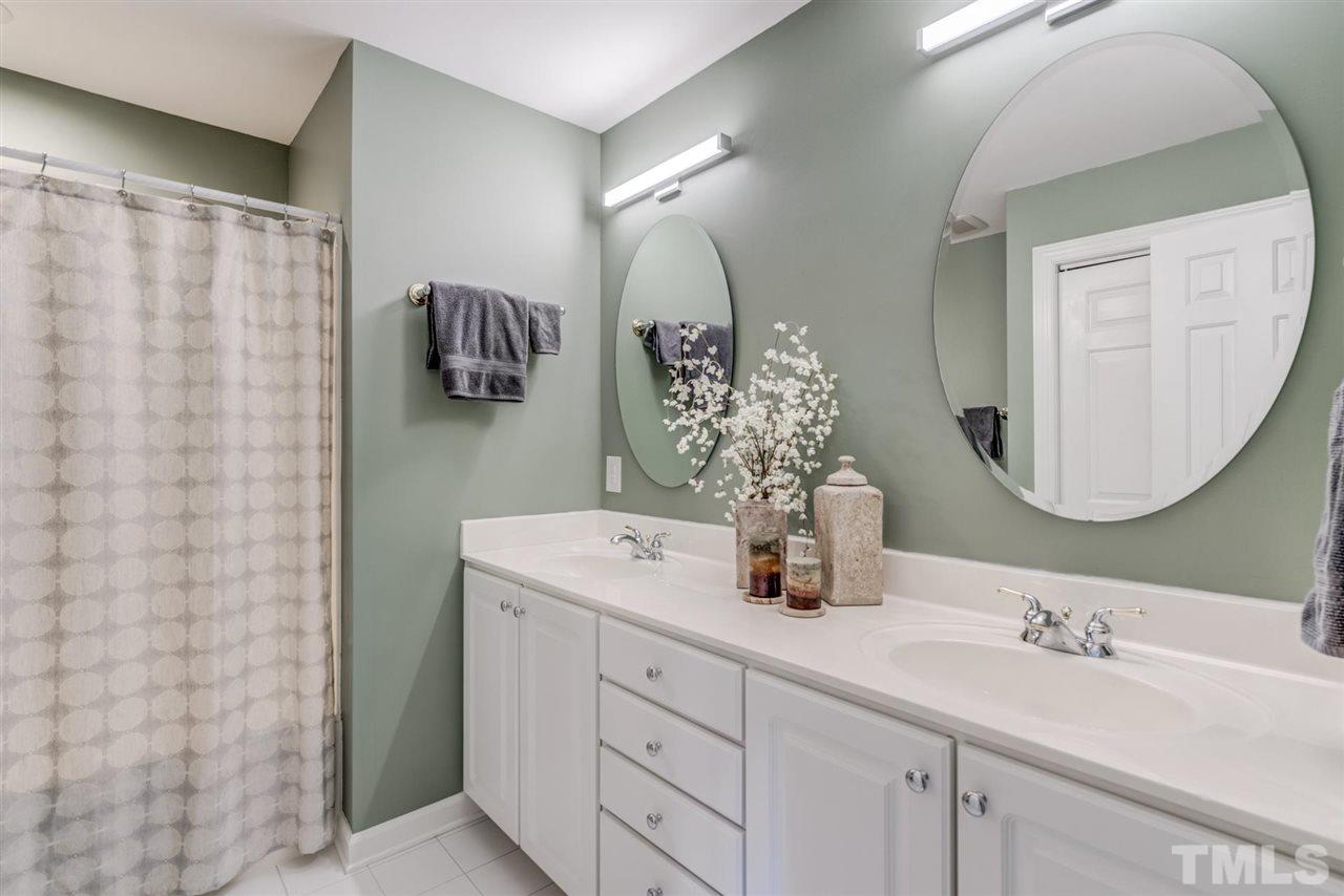 3606 Burwell Rollins Circle Raleigh, NC 27612 - Photo 24 of 30 a bathroom with a double vanity sink and a mirror