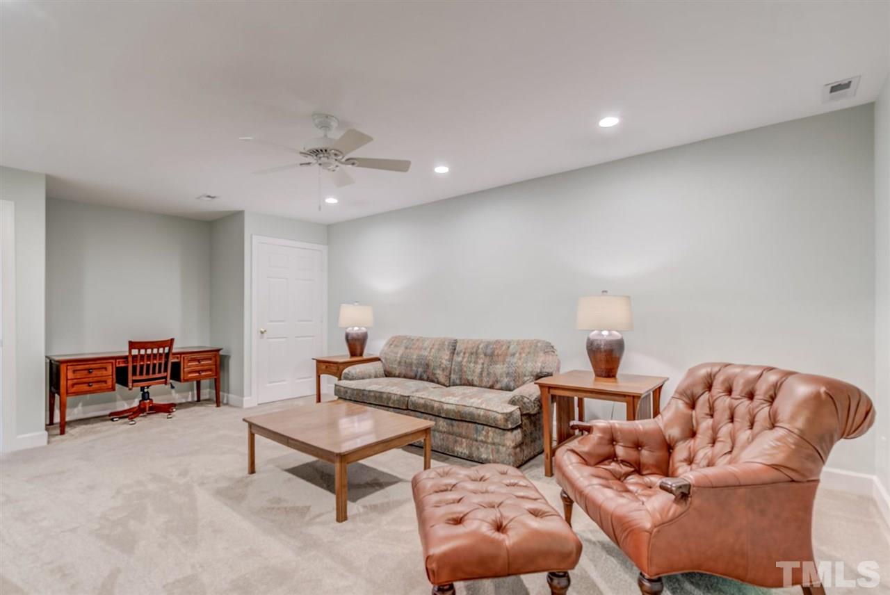 3606 Burwell Rollins Circle Raleigh, NC 27612 - Photo 28 of 30 a living room with furniture and a ceiling fan