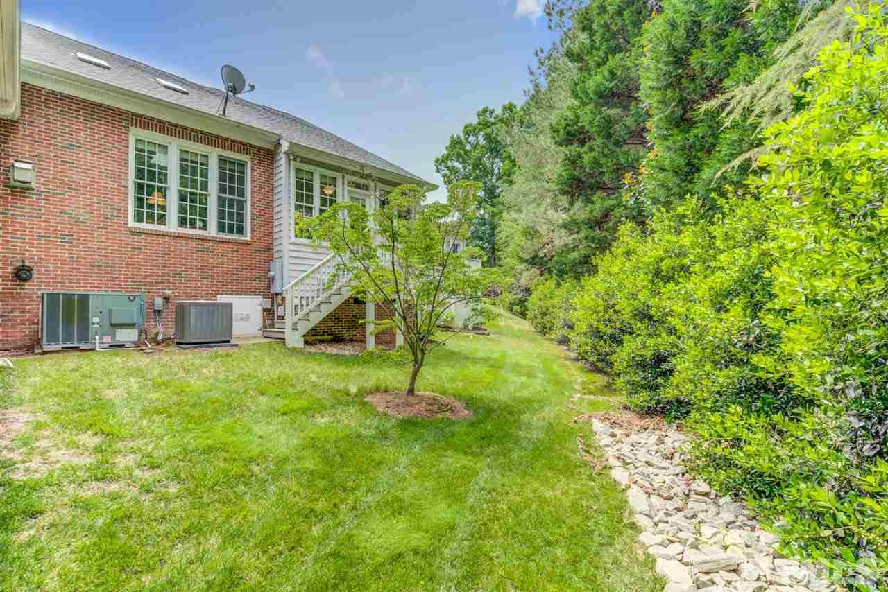 3606 Burwell Rollins Circle Raleigh, NC 27612 - Photo 30 of 30 a backyard of a house with plants and wooden fence