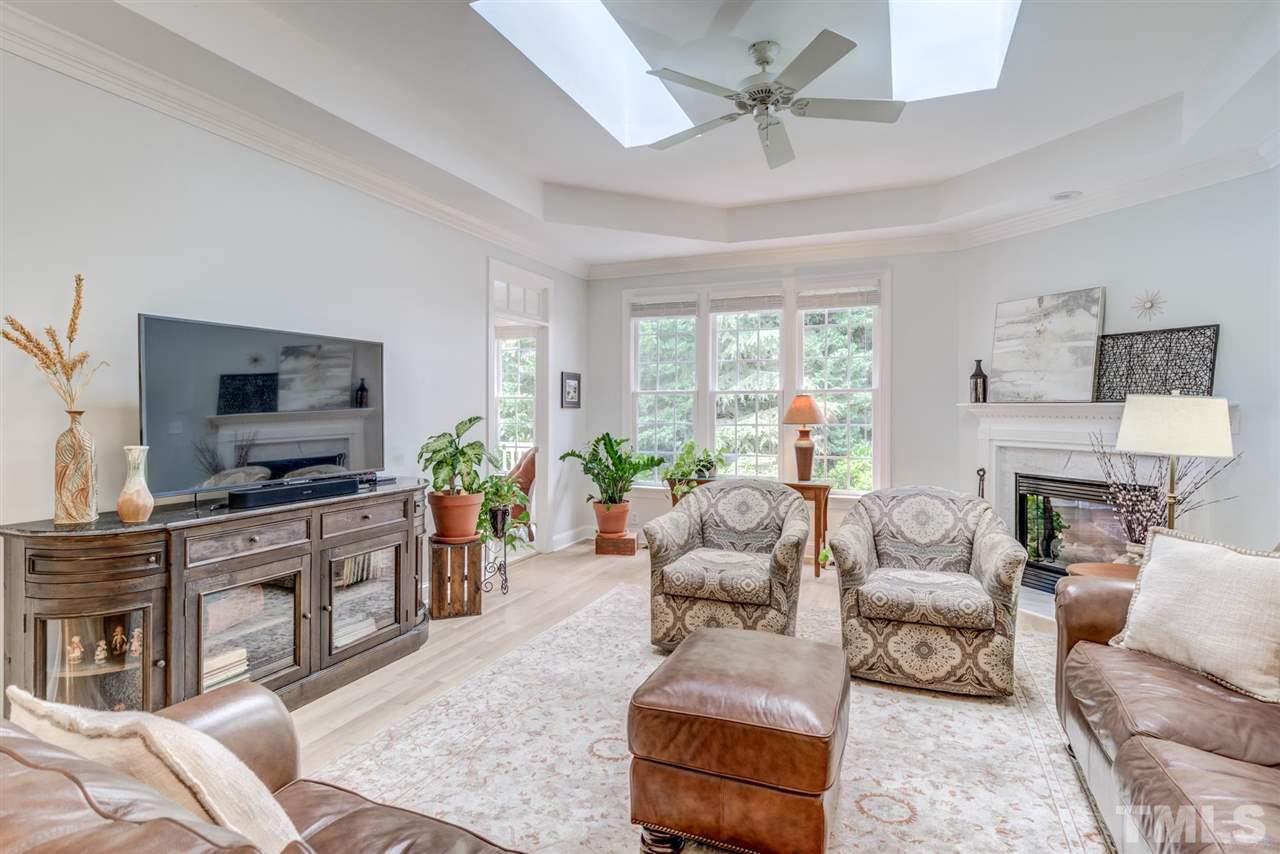 3606 Burwell Rollins Circle Raleigh, NC 27612 - Photo 7 of 30 a living room with furniture a fireplace and a flat screen tv