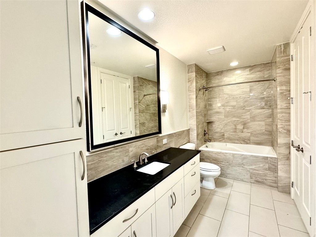 2303 Mid Lane, Unit 318 Houston, TX 77027 - Photo 8 of 25 a bathroom with a double vanity sink toilet mirror and shower