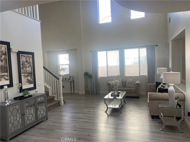a view of living room and furniture with wooden floor