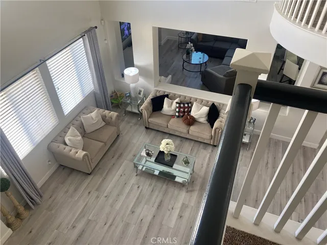 a spacious bedroom with a bed a fireplace and a flat tv screen