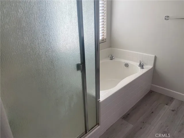 a bathroom with a double vanity sink a mirror and a shower