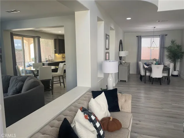 a kitchen with a table chairs refrigerator and microwave