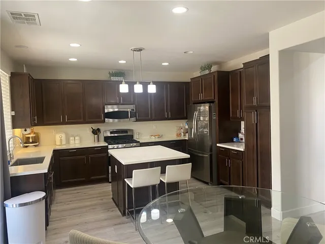 a living room with furniture a flat screen tv and a window