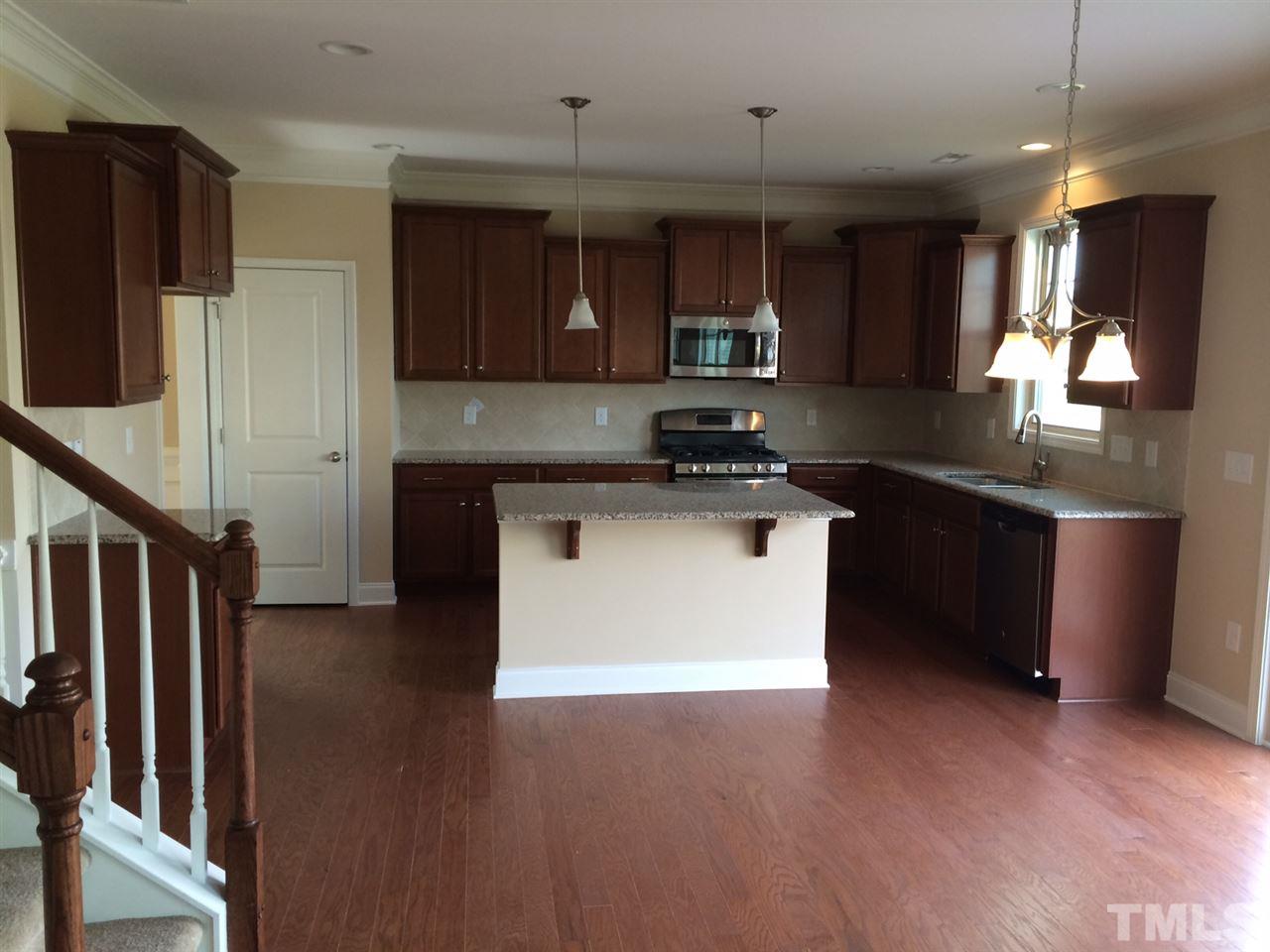 7464 Randshire Way Raleigh, NC 27616 - Photo 13 of 25 a kitchen with stainless steel appliances granite countertop a stove a sink and a refrigerator