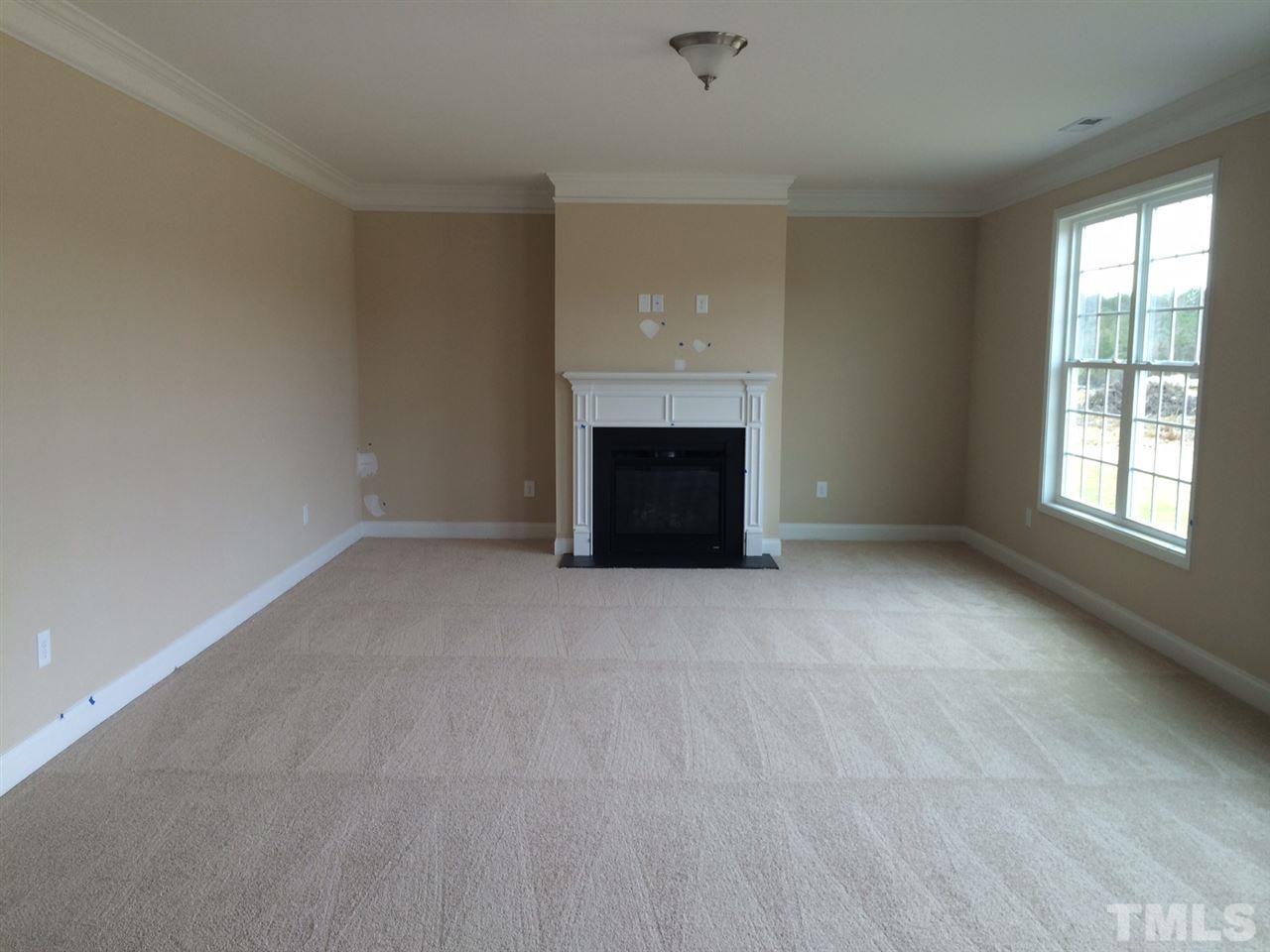7464 Randshire Way Raleigh, NC 27616 - Photo 3 of 25 an empty room with fireplace