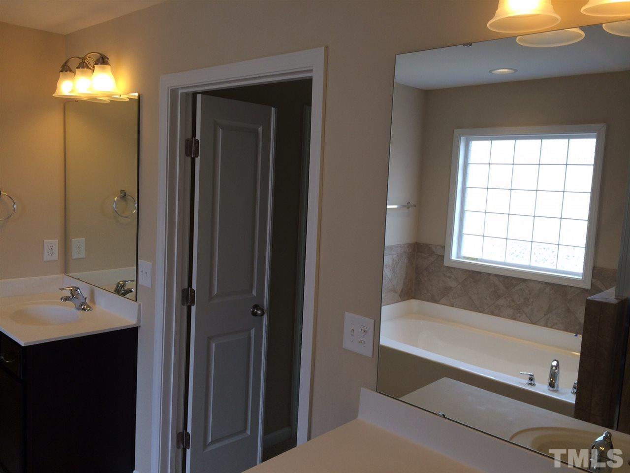 7464 Randshire Way Raleigh, NC 27616 - Photo 10 of 25 a bathroom with a bathtub and a sink