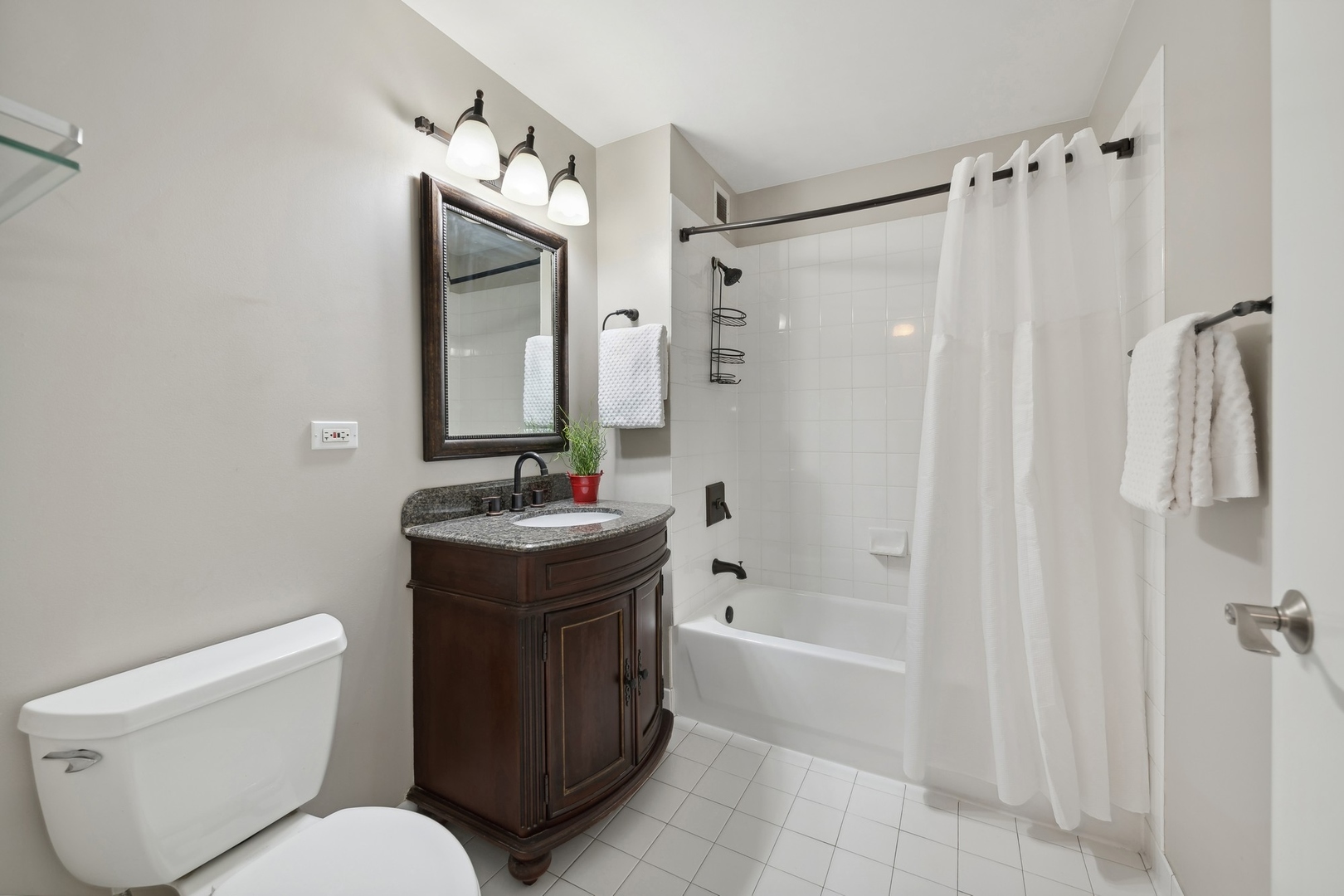 2 East Erie Street, Unit 1501 Chicago, IL 60611 - Photo 13 of 18 a bathroom with a granite countertop toilet sink and shower